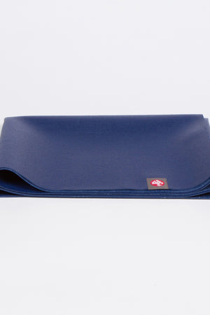 MANDUKA EKO SUPERLITE TRAVEL YOGA MAT IN  NEW MOON AND FOLDED UP IMAGE